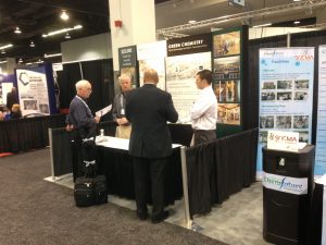 People networking at a trade show booth